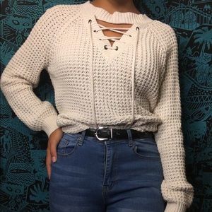 White knit lace up sweater.